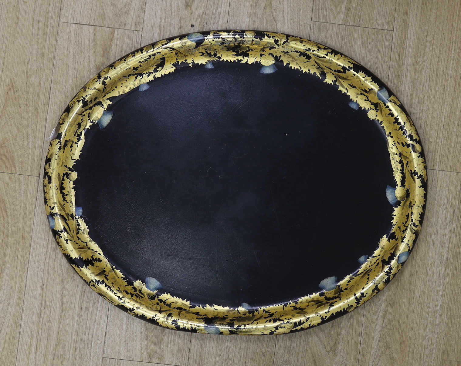 A large Regency oval japanned papier mache tray, 81cm long